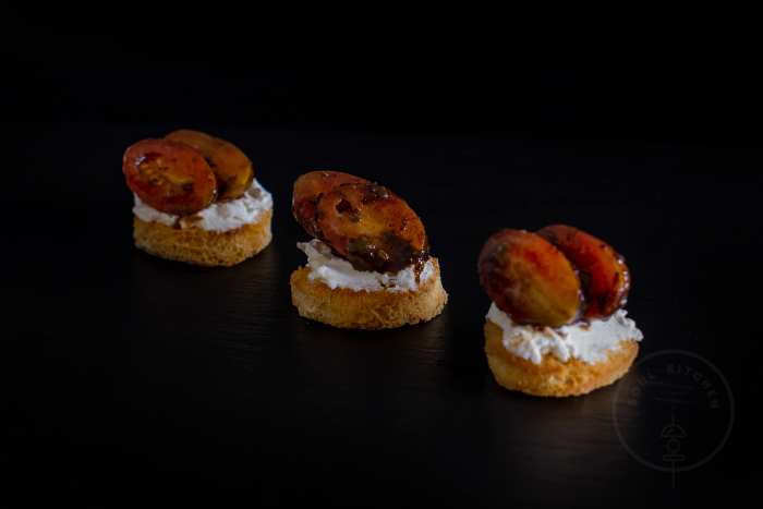 Canape with caramelized tomatoes and cream cheese